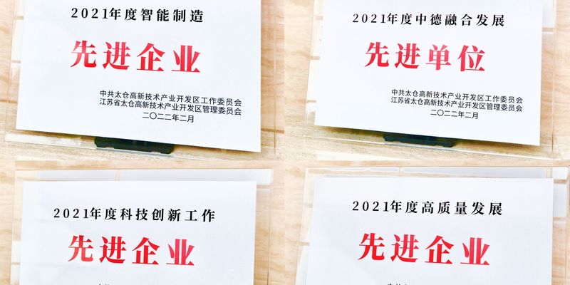 vier weiße Blätter mit roter asiatischer Schrift liegen auf einem Tisch 